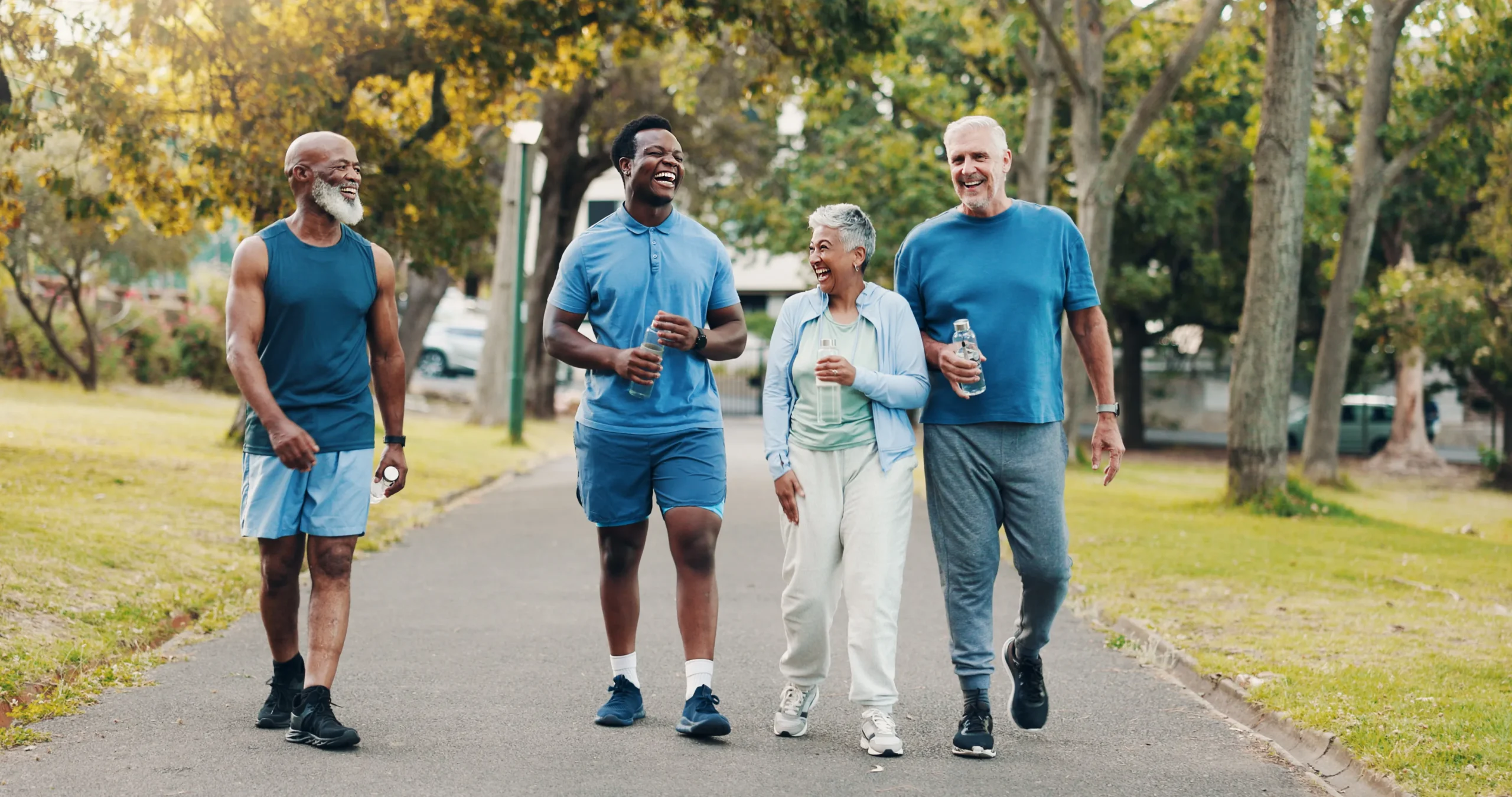 Woman experiencing hip pain while walking in a park with her friends